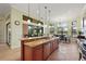 Bright kitchen with granite island, breakfast area, and access to backyard at 9323 San Jose Blvd, Howey In The Hills, FL 34737