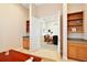 Home office with built-in shelves and view into adjacent sitting area at 9323 San Jose Blvd, Howey In The Hills, FL 34737