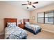 Bedroom with twin beds and ceiling fan at 9323 San Jose Blvd, Howey In The Hills, FL 34737