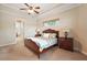 Spacious main bedroom with wood furniture and ceiling fan at 9323 San Jose Blvd, Howey In The Hills, FL 34737