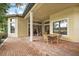 Covered patio with brick flooring and wooden table and chairs at 9323 San Jose Blvd, Howey In The Hills, FL 34737