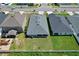 Aerial view of three houses with gray roofs at 74 Polermo Ave, Saint Cloud, FL 34771