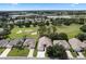 Aerial view of house and neighborhood, showcasing the golf course at 24215 Belle Mede Dr, Leesburg, FL 34748