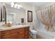 Clean bathroom with a tub shower, vanity, and toilet at 2403 Carriage Hill Way, The Villages, FL 32162