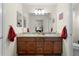 Double vanity bathroom with a large mirror and plenty of cabinet space at 2403 Carriage Hill Way, The Villages, FL 32162