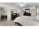 Spacious bedroom with a large TV, dresser, and walk-in closet at 2403 Carriage Hill Way, The Villages, FL 32162