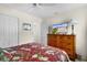 Bedroom with dresser, TV, and floral bedding at 2403 Carriage Hill Way, The Villages, FL 32162