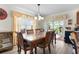 Dining room with glass-top table and access to a screened porch at 2403 Carriage Hill Way, The Villages, FL 32162