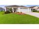 Well-maintained house with a two-car garage and landscaped lawn at 2403 Carriage Hill Way, The Villages, FL 32162