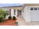 Inviting front entrance with a glass door and landscaping at 2403 Carriage Hill Way, The Villages, FL 32162