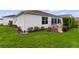 White house exterior with well-manicured lawn and a screened porch at 2403 Carriage Hill Way, The Villages, FL 32162