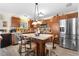 Bright kitchen with island, stainless steel appliances, and wood cabinets at 2403 Carriage Hill Way, The Villages, FL 32162