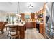 Bright kitchen with island, stainless steel appliances, and wood cabinets at 2403 Carriage Hill Way, The Villages, FL 32162