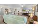 Living area showcasing a light green sofa and a view of the kitchen at 2403 Carriage Hill Way, The Villages, FL 32162