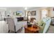 Living room with comfy seating, large windows and a ceiling fan at 2403 Carriage Hill Way, The Villages, FL 32162