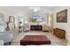 Living room with floral armchairs, a large TV, and a view into the kitchen at 2403 Carriage Hill Way, The Villages, FL 32162