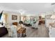 Open living room with tile floors and view into the kitchen at 2403 Carriage Hill Way, The Villages, FL 32162