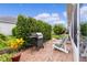 Brick patio with grill and seating area, creating an outdoor oasis at 2403 Carriage Hill Way, The Villages, FL 32162