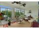 Relaxing sunroom with comfortable seating and ceiling fan at 2403 Carriage Hill Way, The Villages, FL 32162