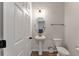 Convenient half bathroom with pedestal sink and toilet at 13409 Lake Yale View Loop, Grand Island, FL 32735