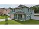 Two story house with a green exterior and a gray roof at 1563 Pier St, Clermont, FL 34711