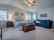 Large primary bedroom with a comfortable sitting area and accent wall at 505 Torres Pl, The Villages, FL 32159