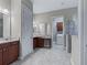 Double vanity bathroom with walk-in shower and access to laundry at 5159 Greens Dr, Lady Lake, FL 32159
