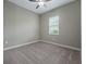 Well-lit bedroom with neutral walls and carpet at 5159 Greens Dr, Lady Lake, FL 32159