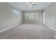 Spacious bedroom with ceiling fan and neutral carpeting at 5159 Greens Dr, Lady Lake, FL 32159
