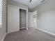 Bright bedroom with carpet, closet, and access to another room at 5159 Greens Dr, Lady Lake, FL 32159