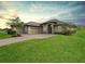 Single-story home with a two-car garage and landscaped lawn at 5159 Greens Dr, Lady Lake, FL 32159