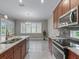 Eat-in kitchen with stainless steel appliances and granite countertops at 5159 Greens Dr, Lady Lake, FL 32159