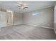 Spacious bedroom with gray carpeting and ceiling fan at 5159 Greens Dr, Lady Lake, FL 32159