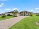 Spacious house with a three-car garage and a lush front yard at 5159 Greens Dr, Lady Lake, FL 32159