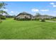 Landscaped side yard with a spacious lawn at 5159 Greens Dr, Lady Lake, FL 32159