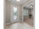 Bright entry with tile flooring, a glass-paned door, and views to an adjacent room at 5159 Greens Dr, Lady Lake, FL 32159