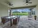Covered patio with pool, seating area, and grill at 5159 Greens Dr, Lady Lake, FL 32159