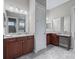 Double vanity bathroom with granite countertops and a linen closet at 5159 Greens Dr, Lady Lake, FL 32159
