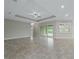Spacious living room with tile floors, coffered ceiling, and access to the backyard at 5159 Greens Dr, Lady Lake, FL 32159
