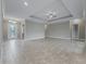 Open living area with tile floors and views of the entry and kitchen at 5159 Greens Dr, Lady Lake, FL 32159