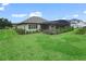 Expansive backyard showcasing home exterior and pool at 5159 Greens Dr, Lady Lake, FL 32159