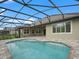 Inviting pool area with screened enclosure and spacious patio at 5159 Greens Dr, Lady Lake, FL 32159