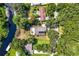 Aerial view of waterfront property with homes and lush green surroundings at 28432 Tammi Dr, Tavares, FL 32778