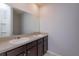 Bathroom with double vanity and dark brown cabinets at 3654 Caspian St, Leesburg, FL 34748
