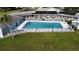 Inviting community pool with a large sundeck and surrounding landscaping at 1660 Elkhart Cir, Tavares, FL 32778