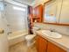 Clean bathroom with a bathtub, toilet and wood vanity at 1660 Elkhart Cir, Tavares, FL 32778