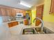 Bright kitchen features ample cabinetry, stainless steel appliances, and a double sink at 1660 Elkhart Cir, Tavares, FL 32778