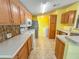 Kitchen with wood cabinets, tiled floors, and a breakfast bar at 1660 Elkhart Cir, Tavares, FL 32778
