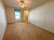 Guest bedroom with window, ceiling fan and carpeted floor at 1660 Elkhart Cir, Tavares, FL 32778
