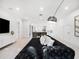 Open-concept living room featuring a tufted sofa and a wet bar at 15617 Pendio Dr, Bella Collina, FL 34756